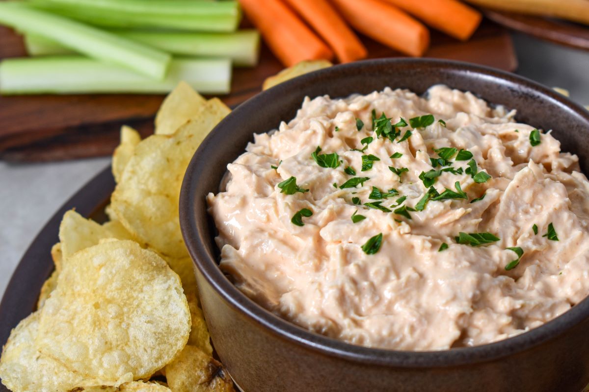 The buffalo dip served in a brown bowl.