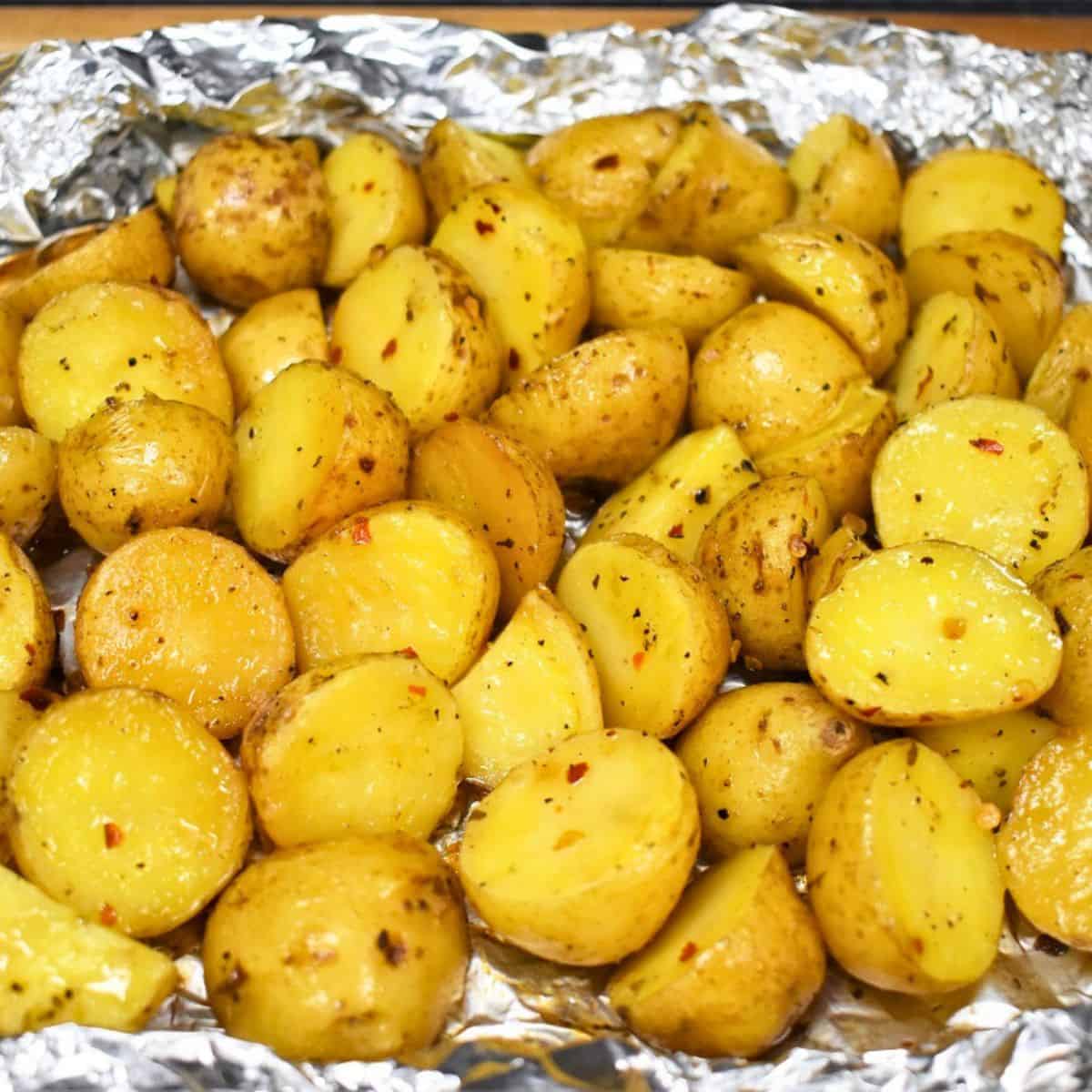 Grilled small gold potatoes in an opened foil pack