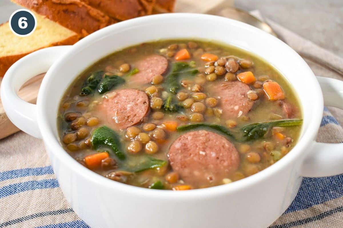 The finished lentil soup in a white bowl.