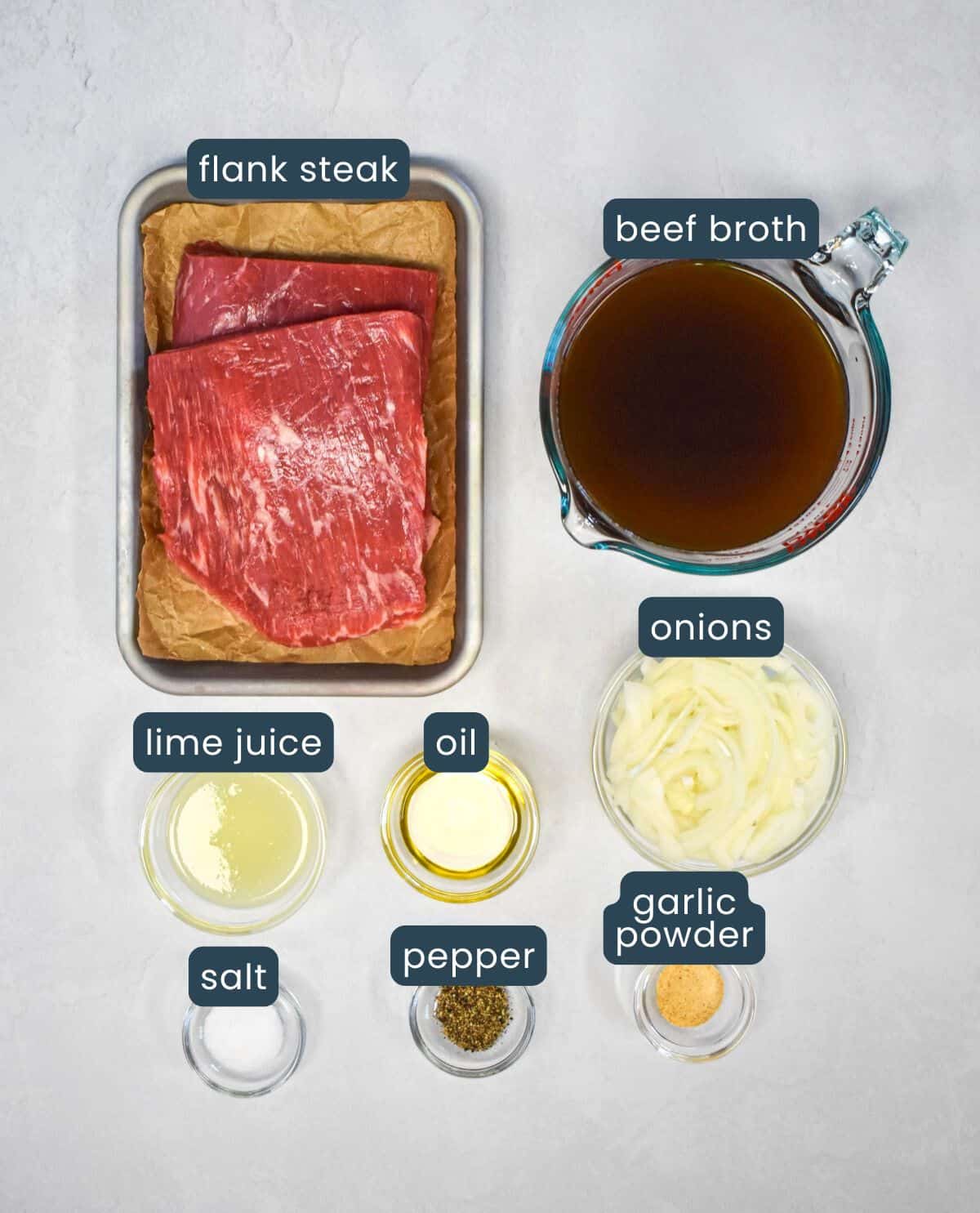 The ingredients for the vaca frita arranged on a white table with each labeled.