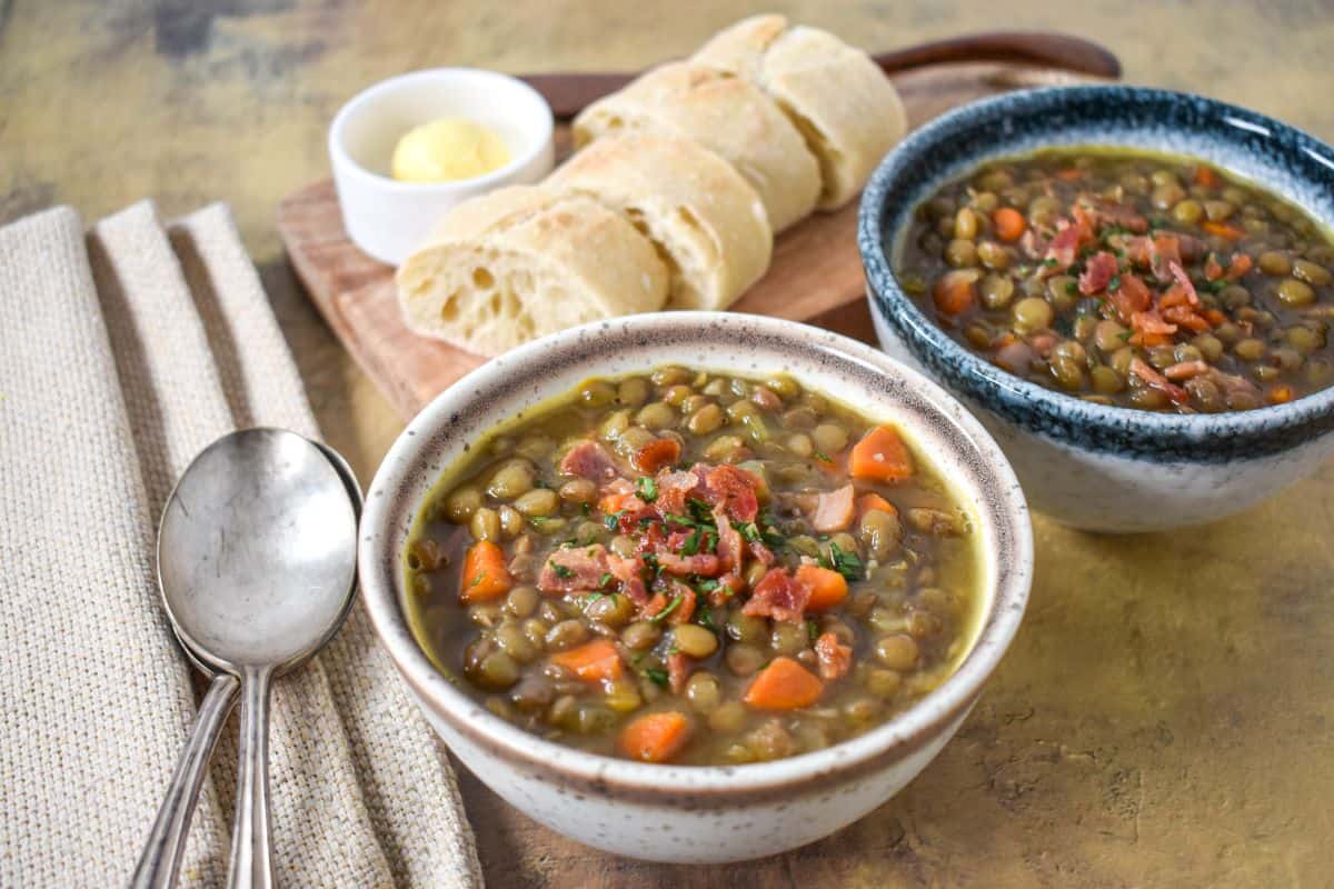 The finished soup served in small bowls, garnished with bacon bits and chopped parsley and served with bread and butter.