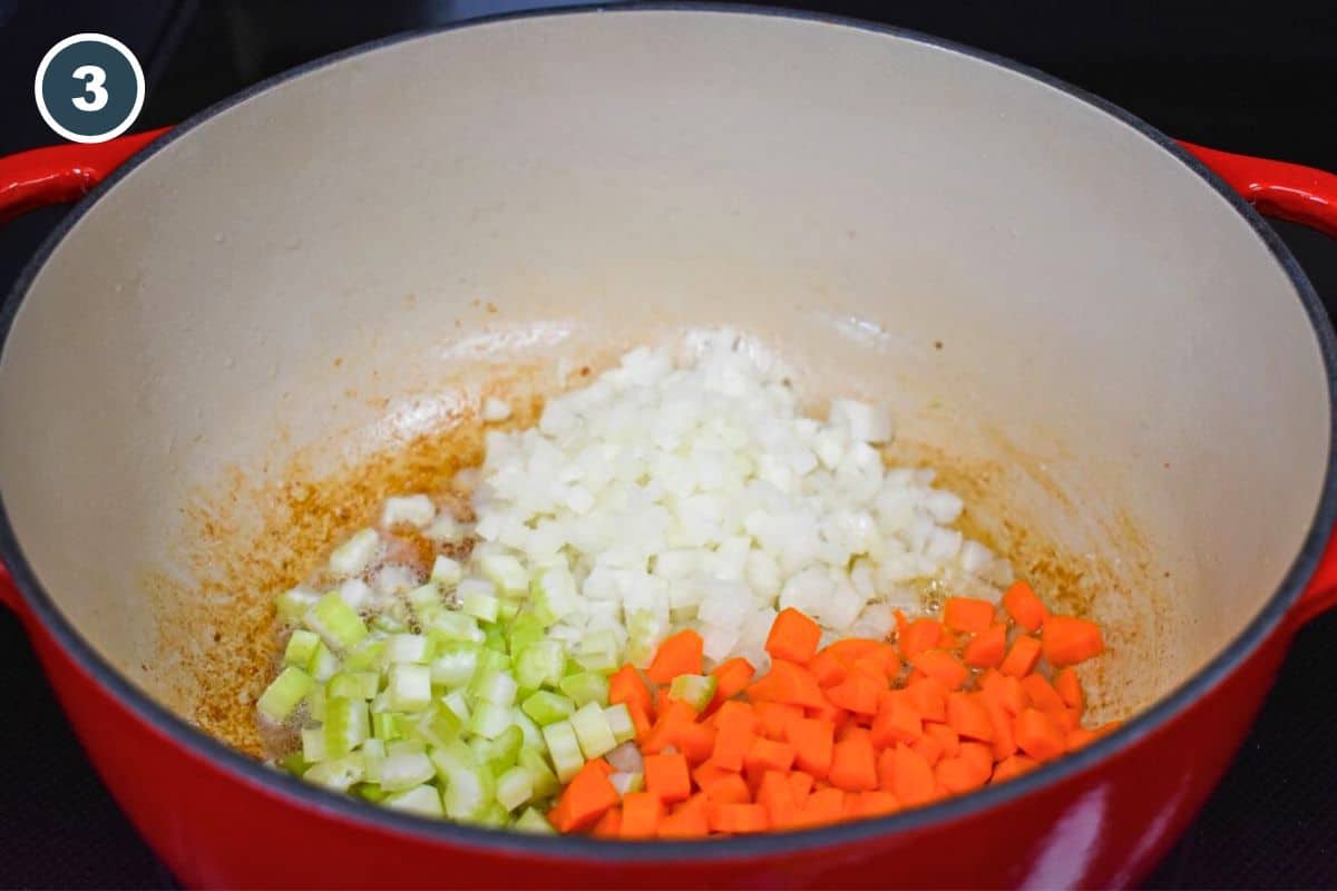 Diced onion, carrots, and celery in a large pot.