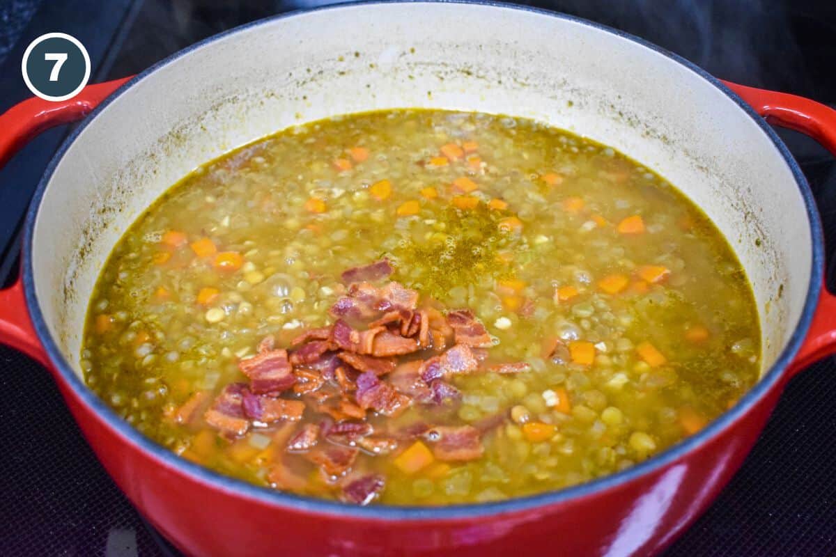 Crispy bacon pieces added to the soup in the pot.