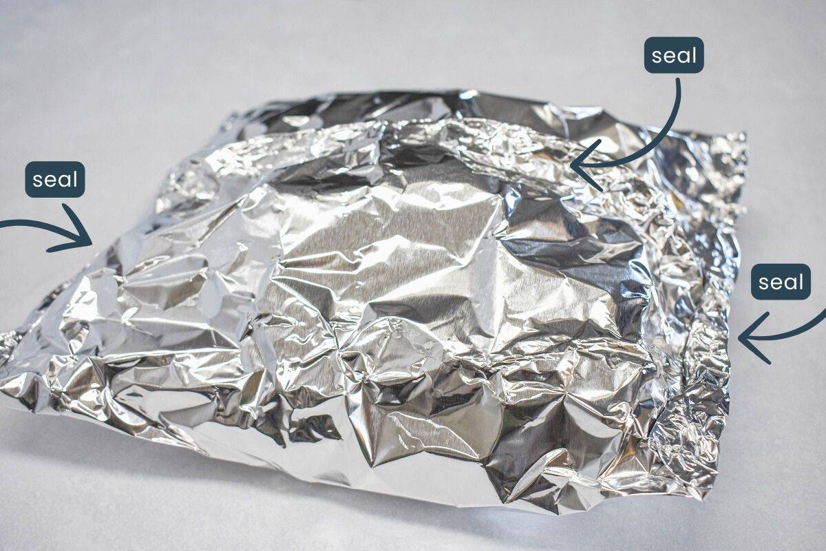 The sealed foil packet on a white table.