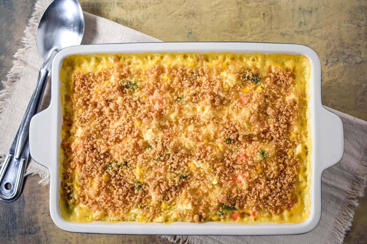 Baked chicken and rice casserole in a white dish with a golden breadcrumb topping.