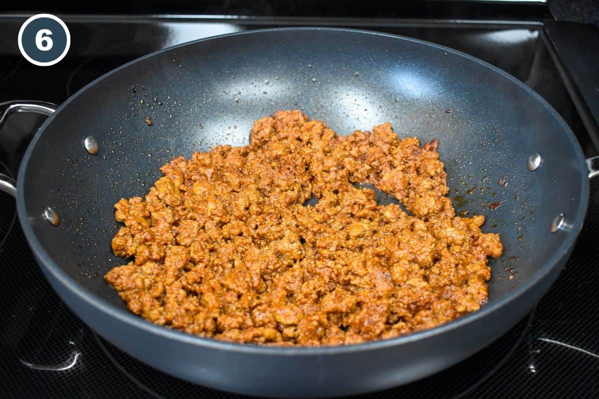 The cooked seasoned beef in a large, black skillet.