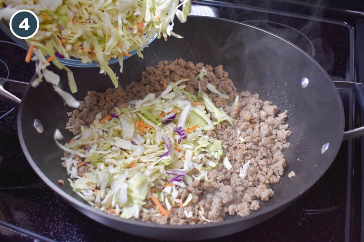 Shredded cabbage being added to browned turkey in a large skillet.