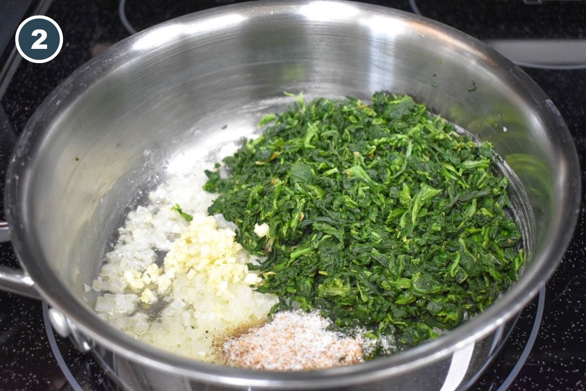 Spinach, garlic, onions, and seasonings added to the pan.