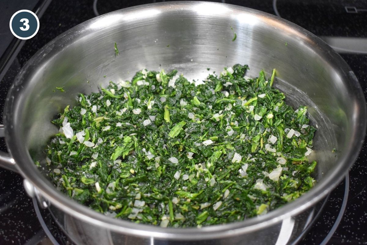 The spinach mixture cooking down with onions and garlic.