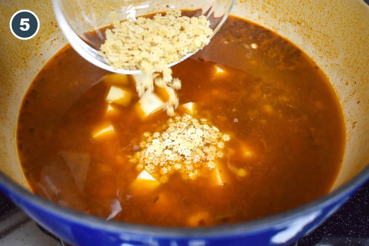 Small pasta being added to the soup.