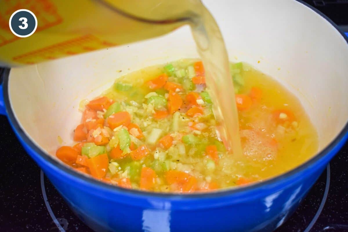 Chicken broth being added to the sauteed vegetables.