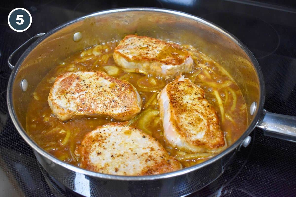 The chops in the pan with the onion sauce.