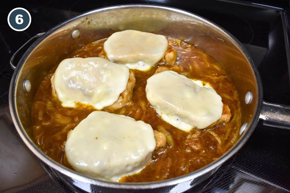 The finished chops with melted cheese on top still in the skillet.