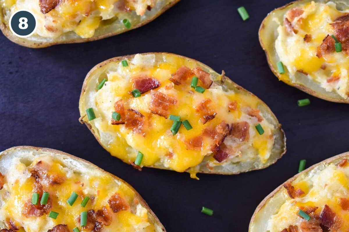 Cheesy stuffed potato halves are baked until golden and topped with crispy bacon and fresh chives.