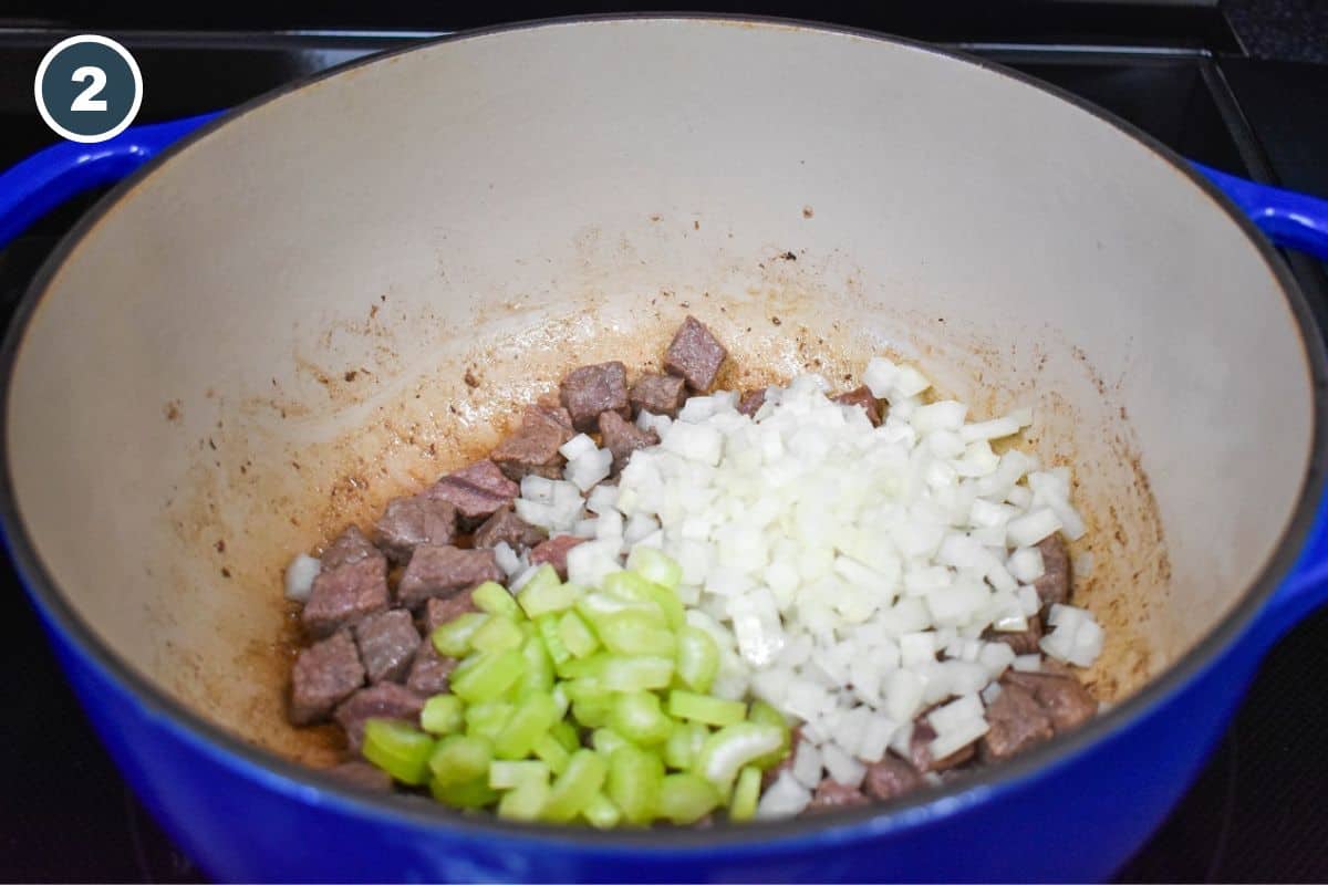 Diced onions and celery added to the browned beef in the pot.