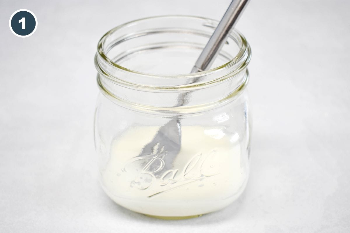 Cornstarch dissolved in water in a mason jar with a fork to mix.