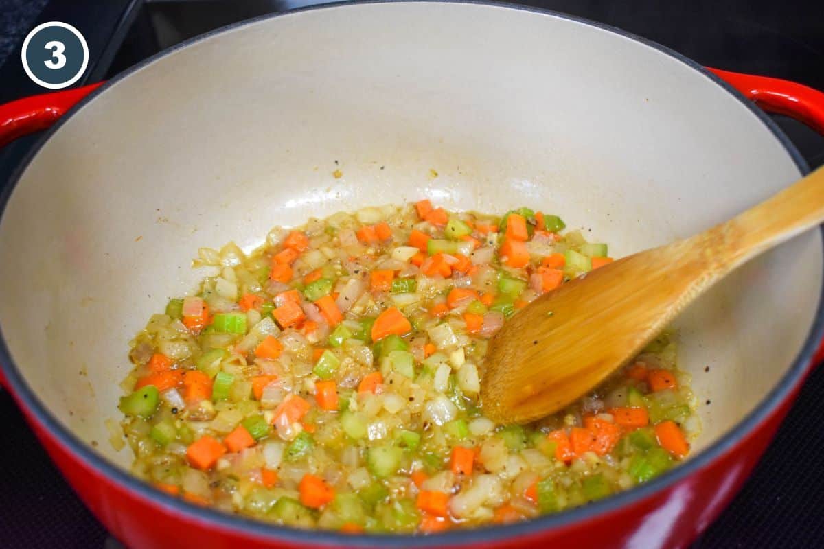 Diced vegetables in a little white wine in a large pot.