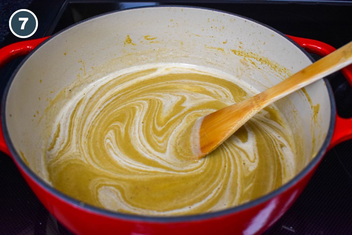 Half and half being stirred into the soup.