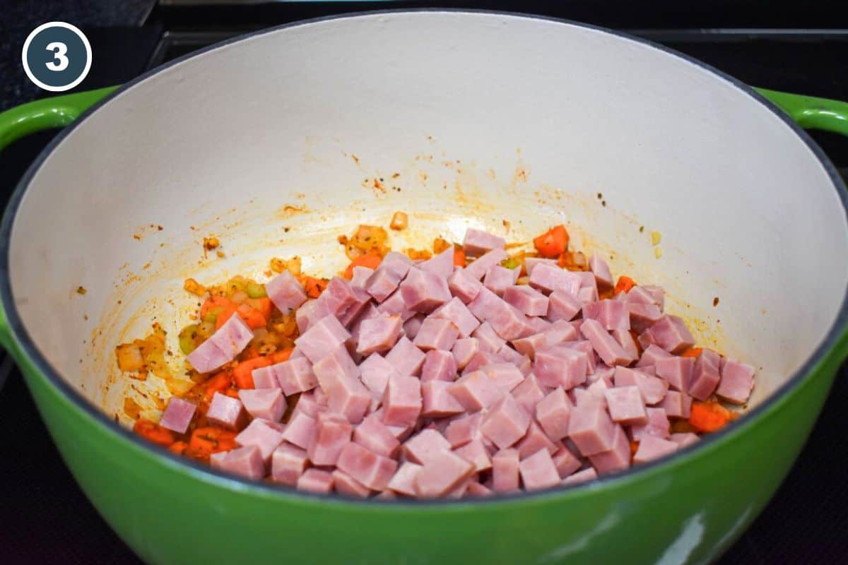 Diced ham added to the vegetables in the Dutch oven.