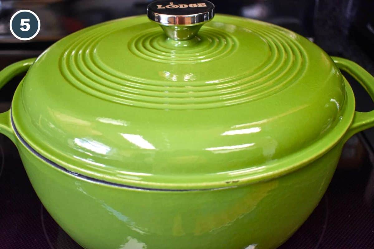 A green Dutch oven covered with its lid.