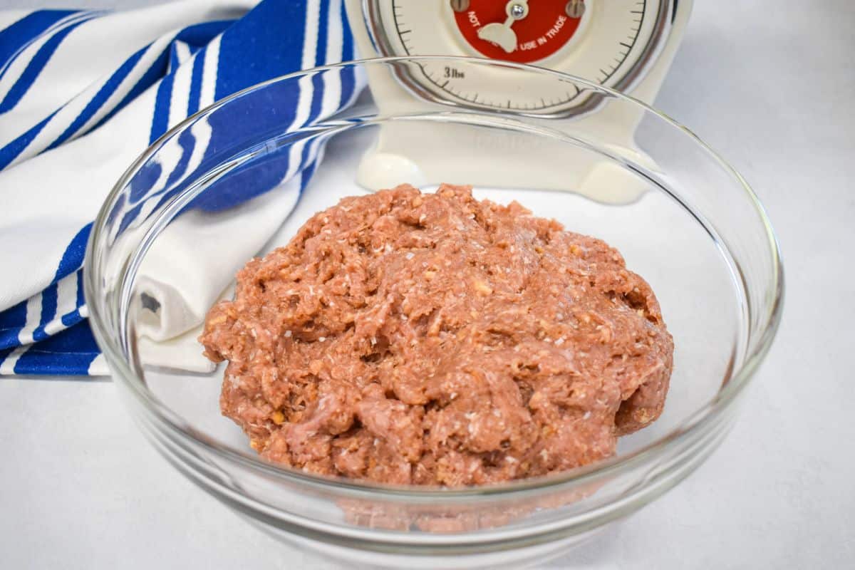 2- Mixed turkey meatloaf mixture in a glass bowl, ready to be shaped, with a vintage kitchen scale in the background.